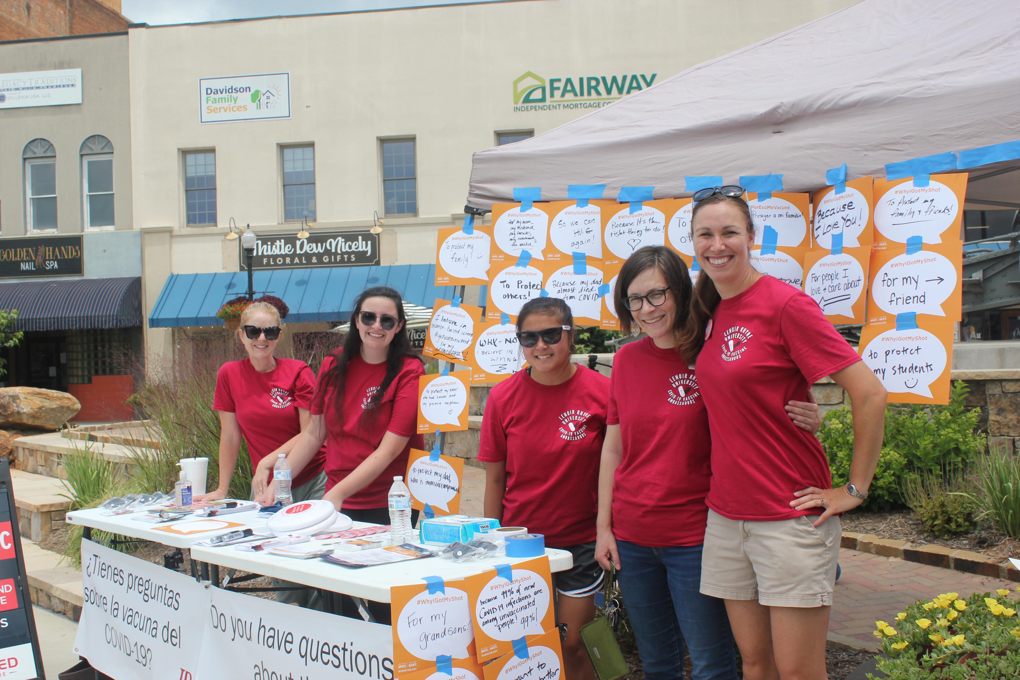 Taylor Newton, Ph.D., far right, stands with a group of student volunteers at an outdoor event