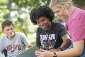 Students collaborating outdoors on campus