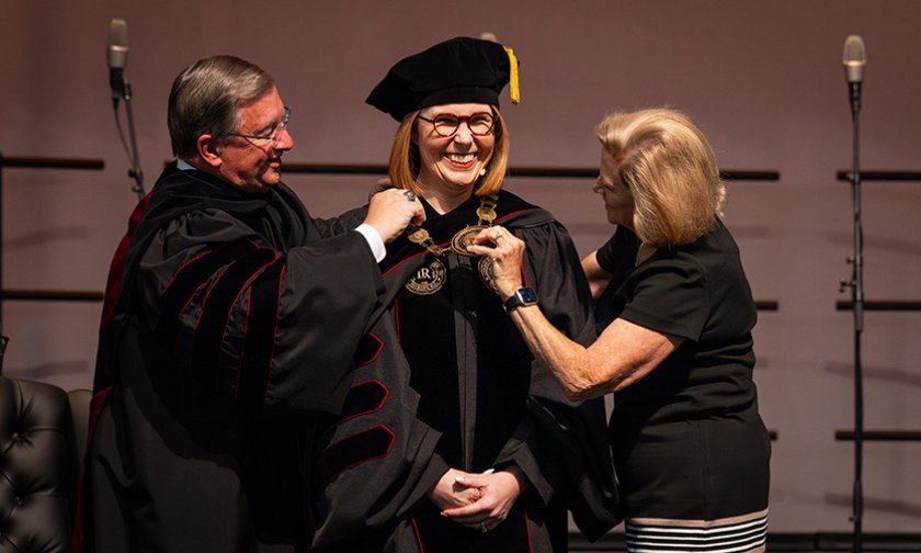 Mickey Payseur and Madeleine Dassow place the presidential medallion on Summer McGee