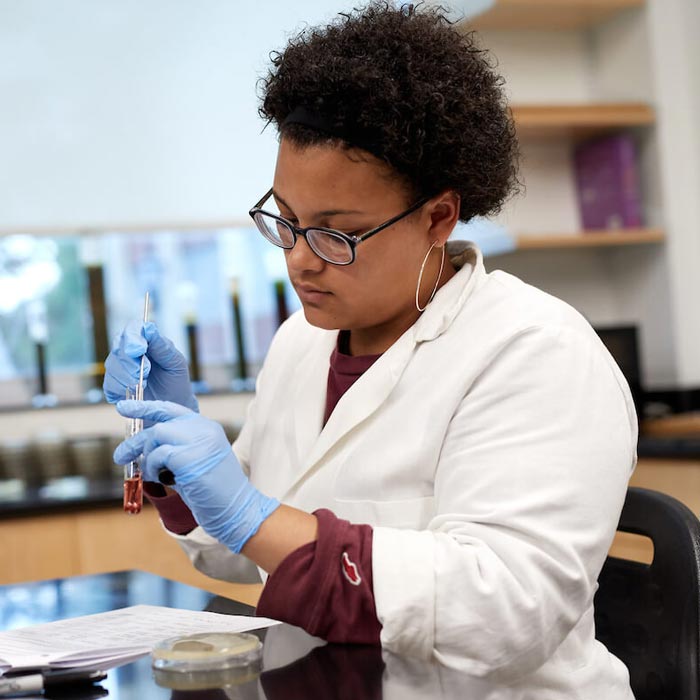 Student working with test tube in lab