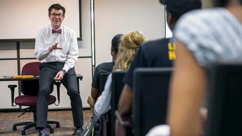 Professor talks to students from front of classroom