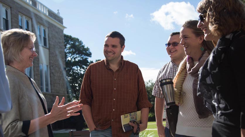 LTSS students talk with a professor outside after a class