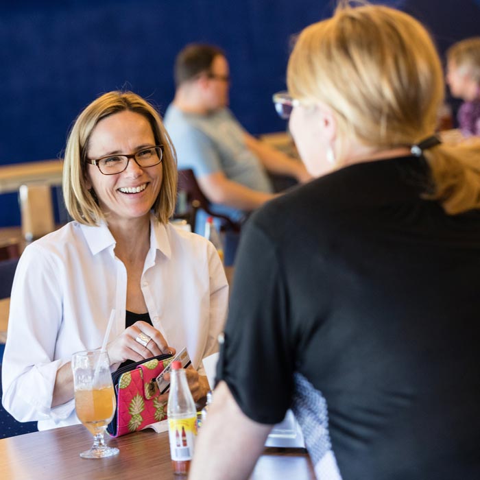 Two LTSS students talking at a table during class break