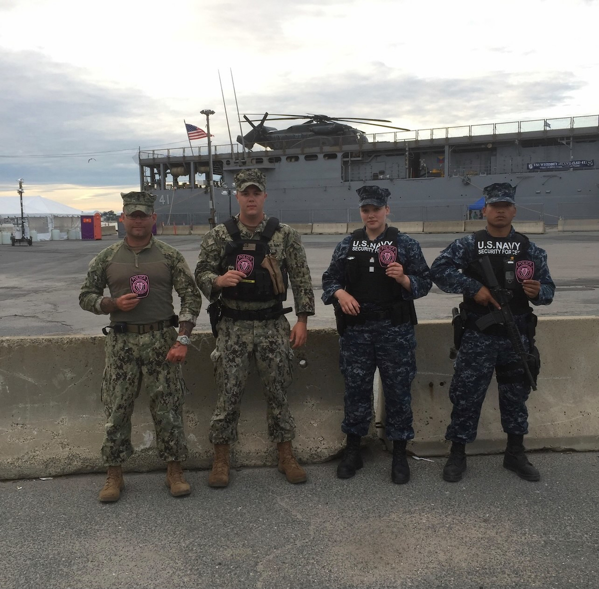 Amy Sain, third from left, stands outside with her fellow Navy men outside in front of a ship