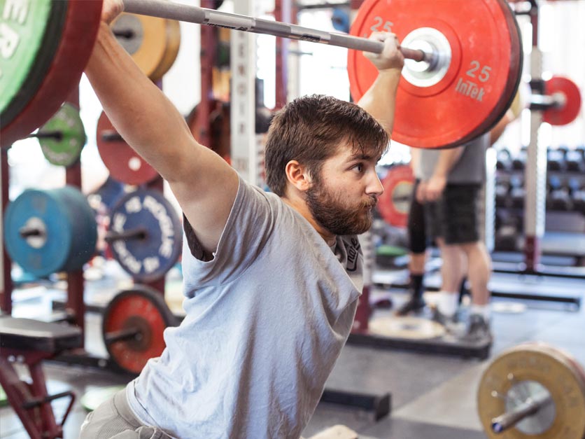 Tynan O'Connor lifting weights in weight froom