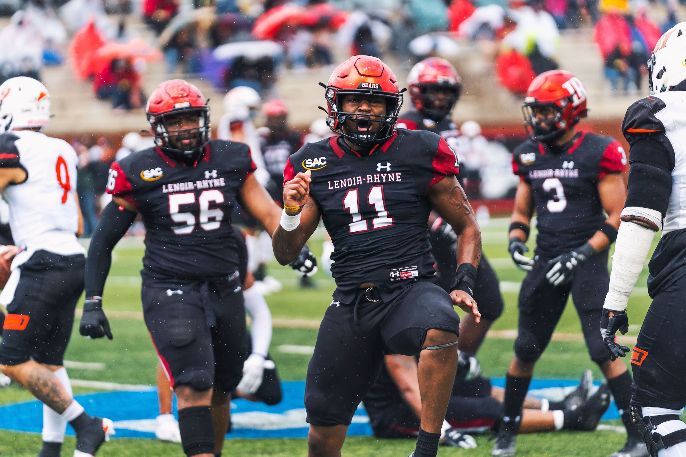 Eric Jackson stands on the football field during a game with his teammates