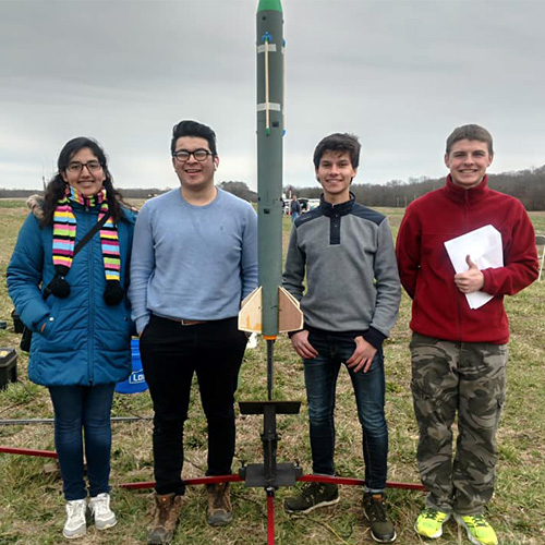 Members of the rocket team pose with a prototype rocket