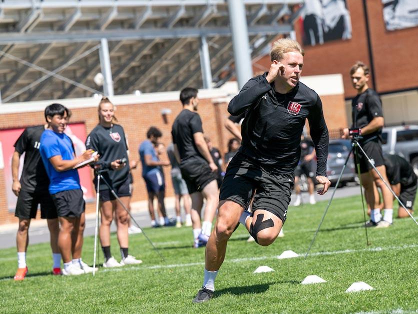 Exercise science student running during group activity with classmates