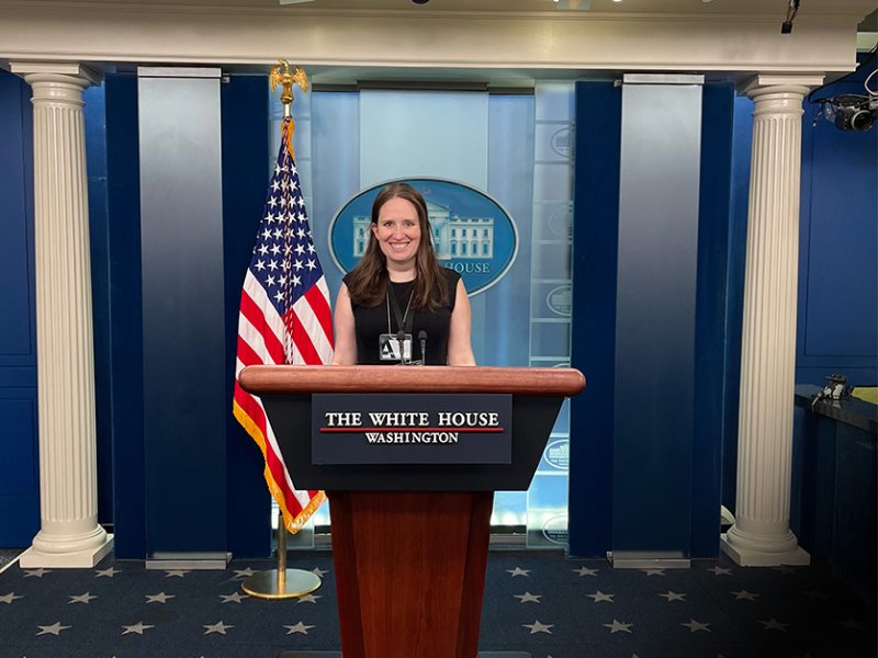 Danielle Battaglia stand at the podium in the White House press briefing room.
