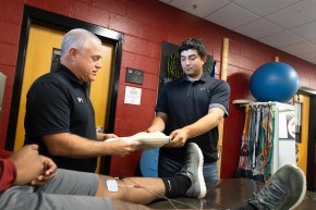 Michael Flicker and Andy Lopez stand inside a room