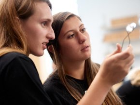 Two students look at experiment in a science lab