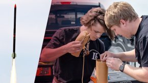 Two students working on a rocket with a rocket flying in the air