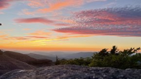 A sunset at dusk over a mountain range