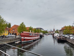 Boats sit in a canal in Copenhagen