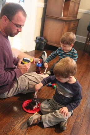 David Dreyer sits on the floor with his two young children and plays