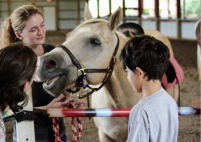 Rising Hope Farms students and volunteer with horse