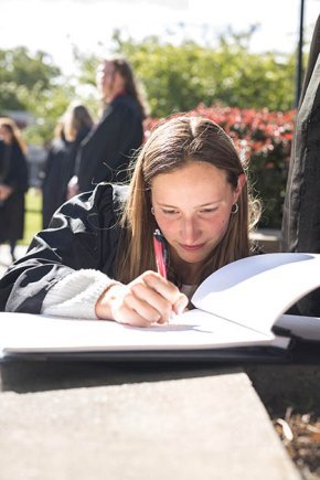 Lisa Boernigen signs the graduation book