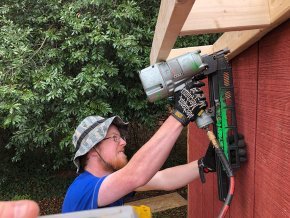 William Blair working with a nail gun on a construction site