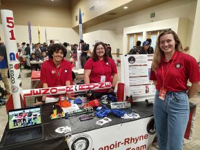 Rocket team members in exhibit hall at Spaceport America