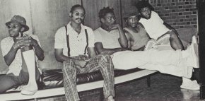 Five male students sit together in a 1974 black and white photo