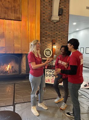 Students confer in front of the Cromer Center fireplace for Bears Give Back
