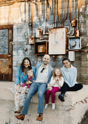 Rachel Tenny poses outside for a photo with her two daughters, husband and au pair while outside