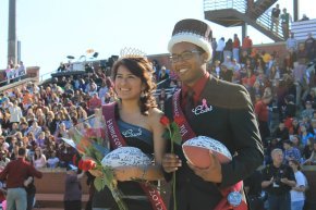 Rosa Reyes, left, and Joshua Mackey, right, smile while being crowned Homecoming king and queen
