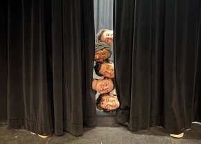 The five members of Bear With Us show their faces lined up between two curtains