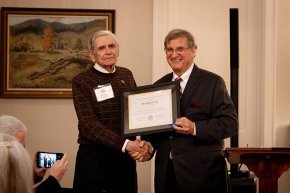 Charles Cooke receives his alumni award from President Whitt
