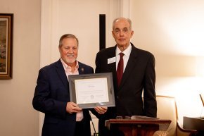 John Love receives his alumni award from Andy Anderson