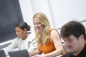 Students work at laptops in the classroom
