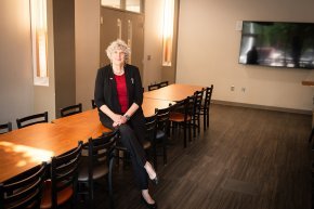 Kate Esch leans on a table in the space designated for the new food pantry
