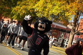 Joe Bear waves to the crowd at the homecoming parade