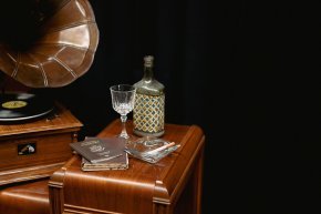 Stage props for Cabaret--gramophone, decanter, glass, passport, ashtray on a table