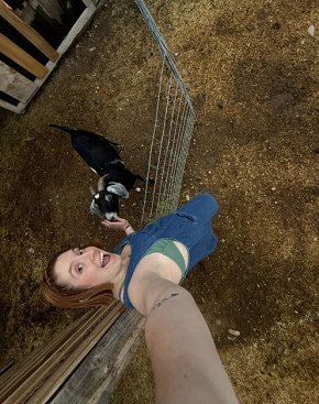 Kaylyn Hall takes a selfie with a baby goat.