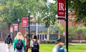 Students walk on campus in front of Rudisill Library
