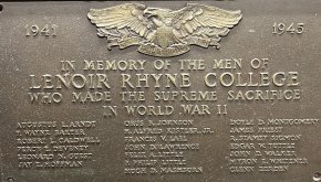 A bronze plaque showing the names of students and alumni who died in World War II
