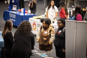 Students visit tables at a career fair in Hickory