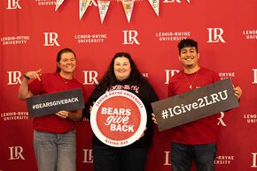 Ivy Throneburg, Stephanie Roberts, Diego Sanjuan holding BGB signs