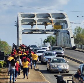 Choir students from Lenoir-Rhyne and Southeastern Louisiana cross the Edmund Pettus Bridge