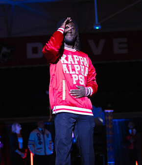 Kappa Alpha Psi member showing colors and letter in student life awards fashion show