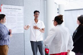 Student explaining a display at 2026 SOURCE Day.