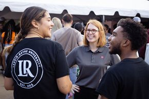 Summer McGee chats with two students at the President's Cookout on Welcome Weekend