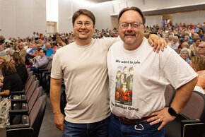 Allen and Mike Hammock stand in the audience in PE Monroe
