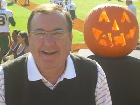 Mike Hogewood next to an ACC themed jack-o-lantern