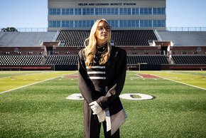 Lindsey Gustafson in uniform aligned with Moretz Stadium box in background