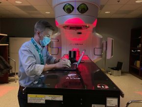 Spencer Welland working in a radiation therapy lab.