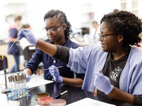 Two students work in chemistry lab on assignment