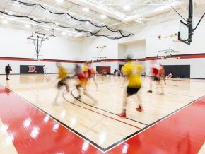 Students playing basketball in the intramural gym