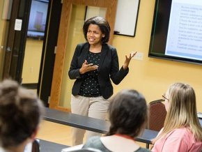 Dr. Kimberly Price teaches in front of a classroom.